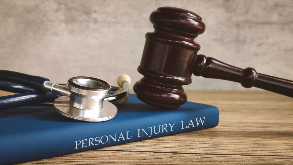 A gavel and stethoscope rest on a blue book titled