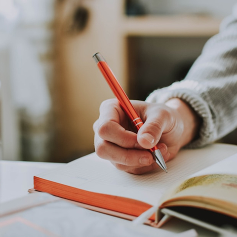 Attorney writing notes in a notebook